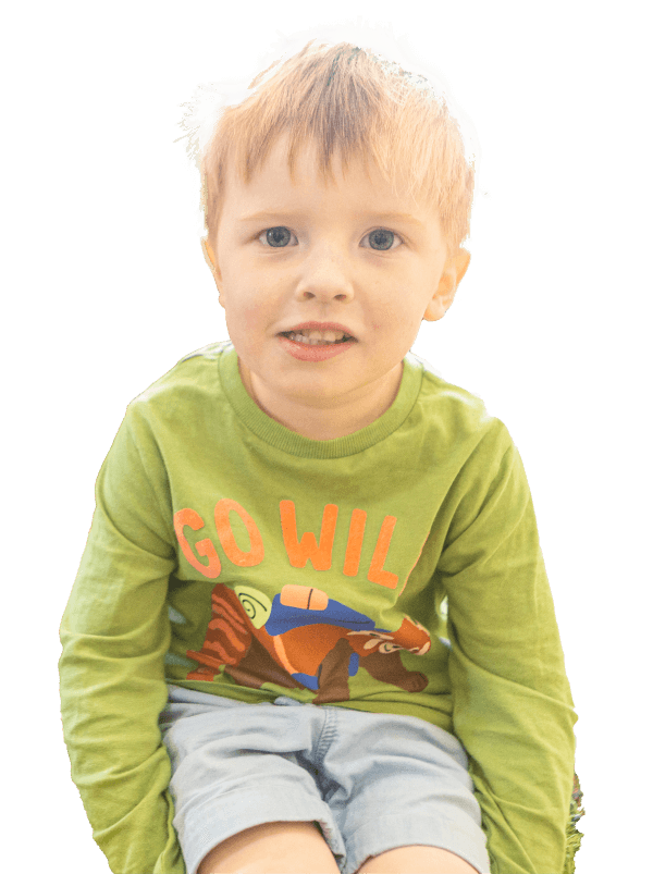 Boy sitting down similing at St Martins Pre School